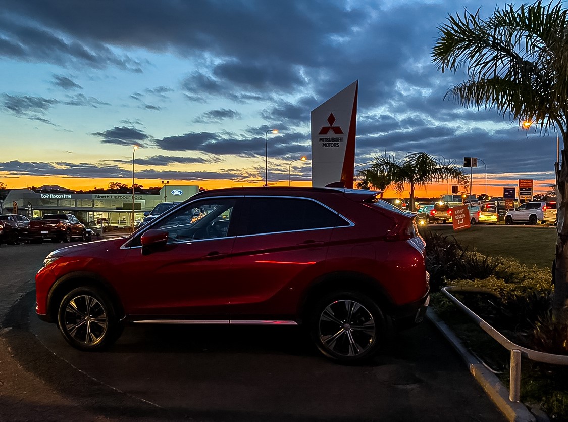 Simon Lucas Mitsubishi Dealership with a red Eclipse Cross on its yard 
