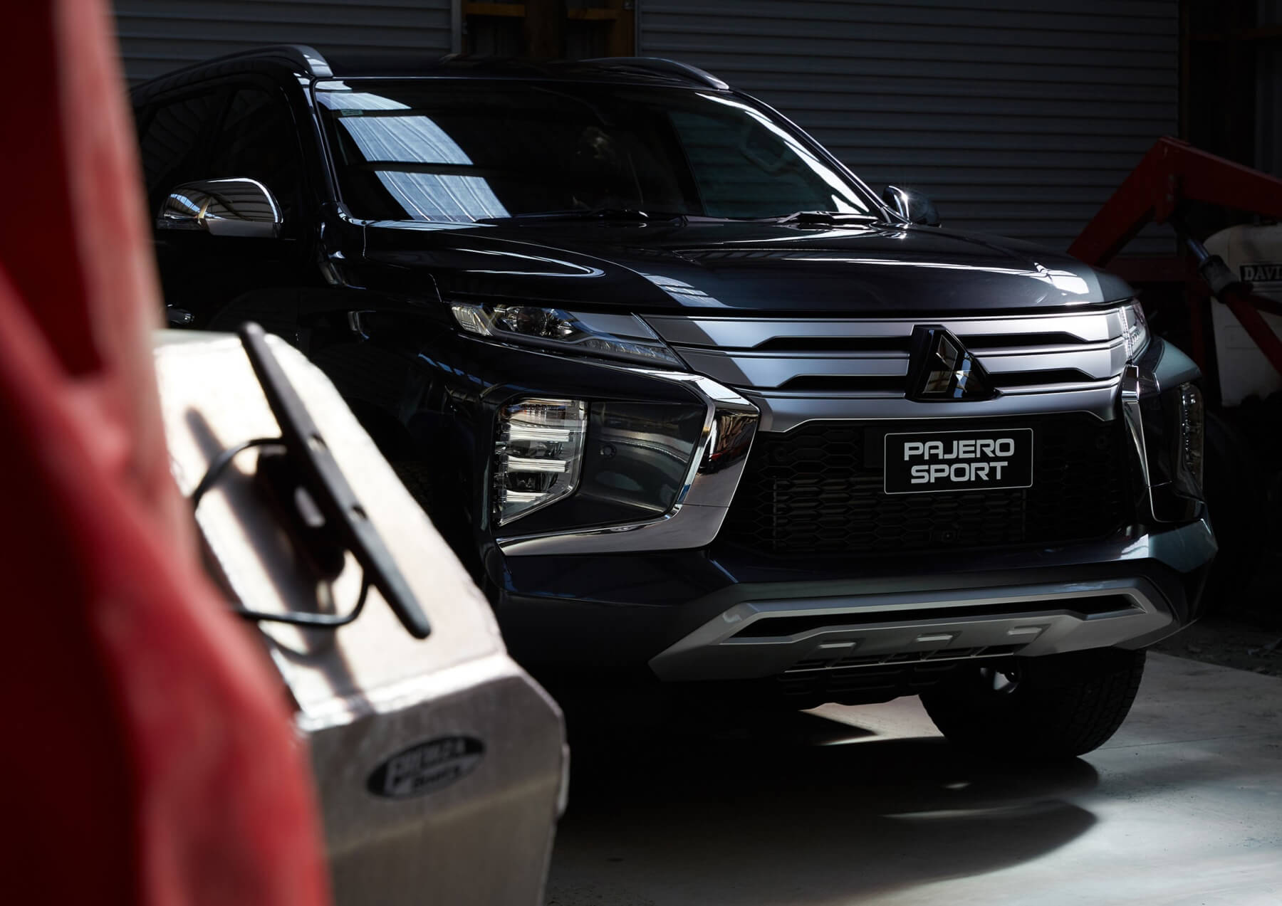 Front of a black Pajero Sport parked in garage