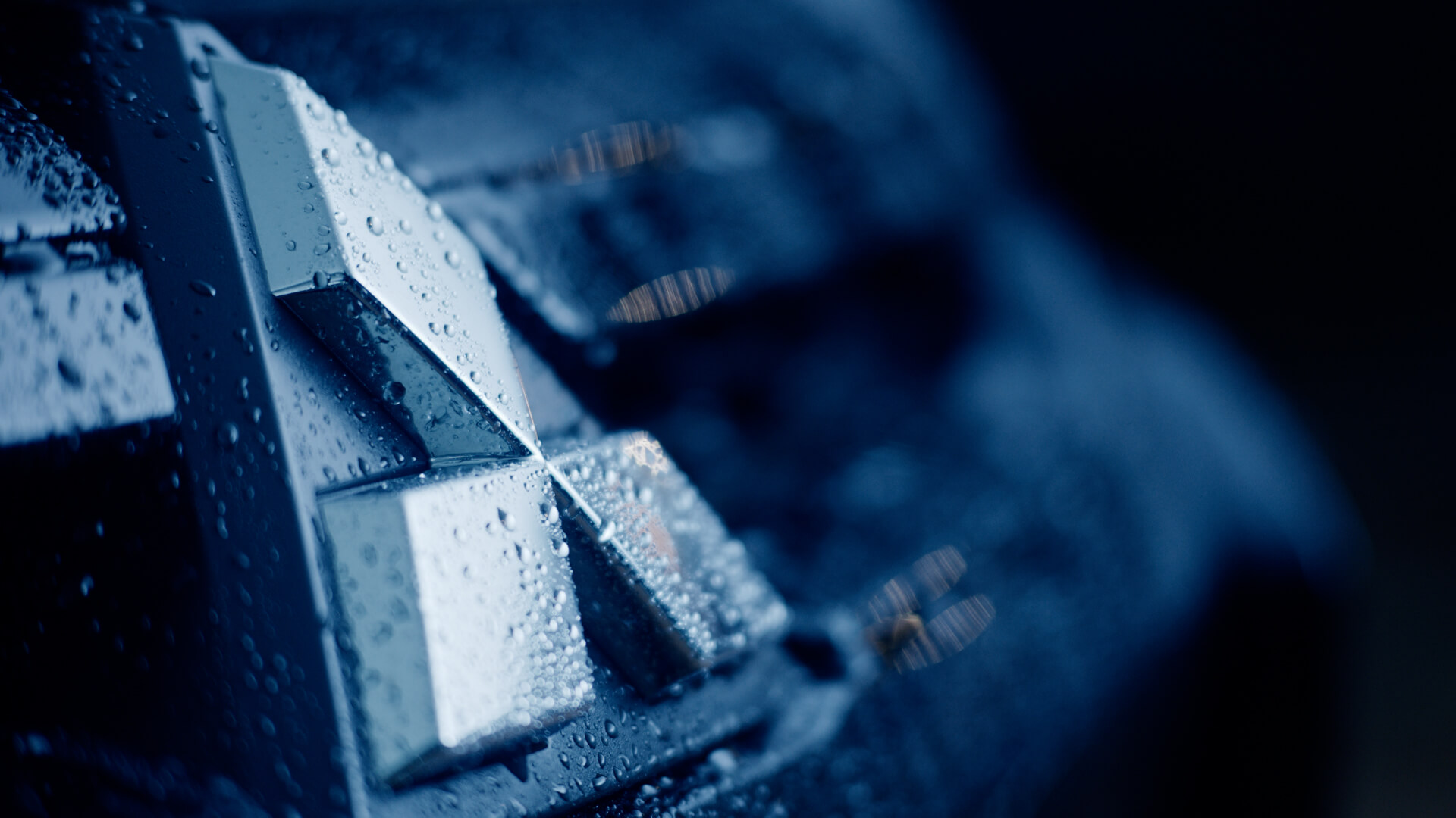 A close up, macro photography shot of the Mitsubishi diamond badge with rain drops on it