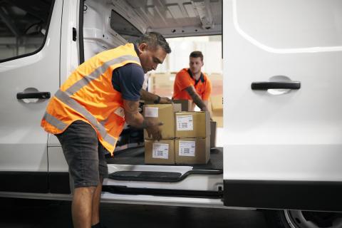 Worker offloading boxes from Express Van
