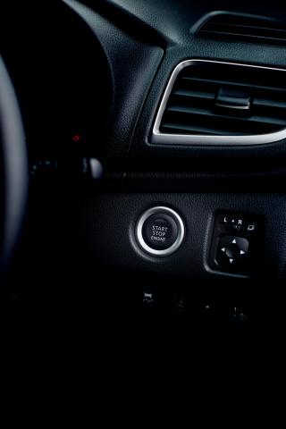 A close up of the push start ignition button of a Triton
