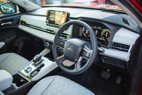 Driver's perspective of steering wheel controls, digital dashboard, and infotainment system